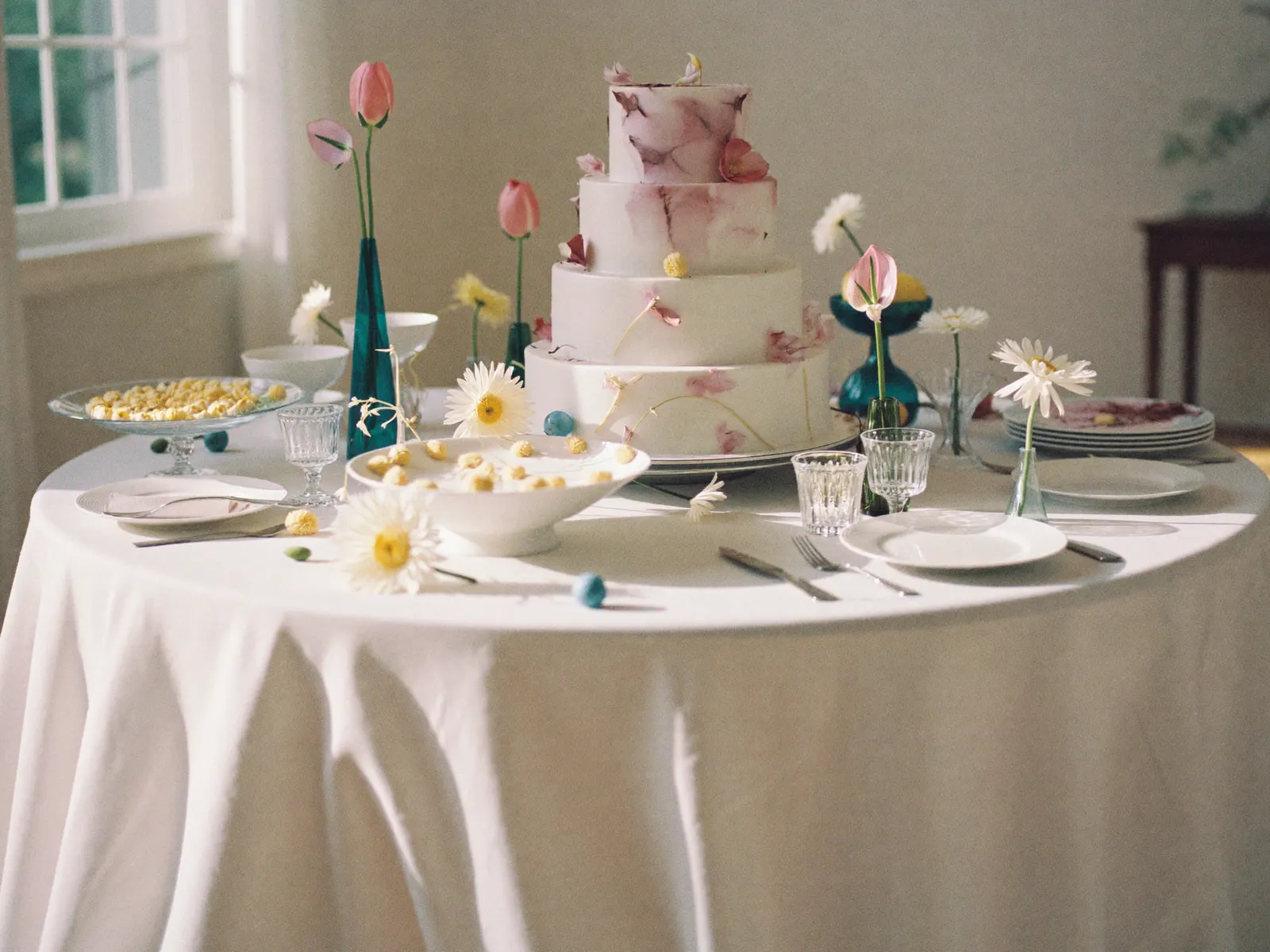 A styled cake table with florals