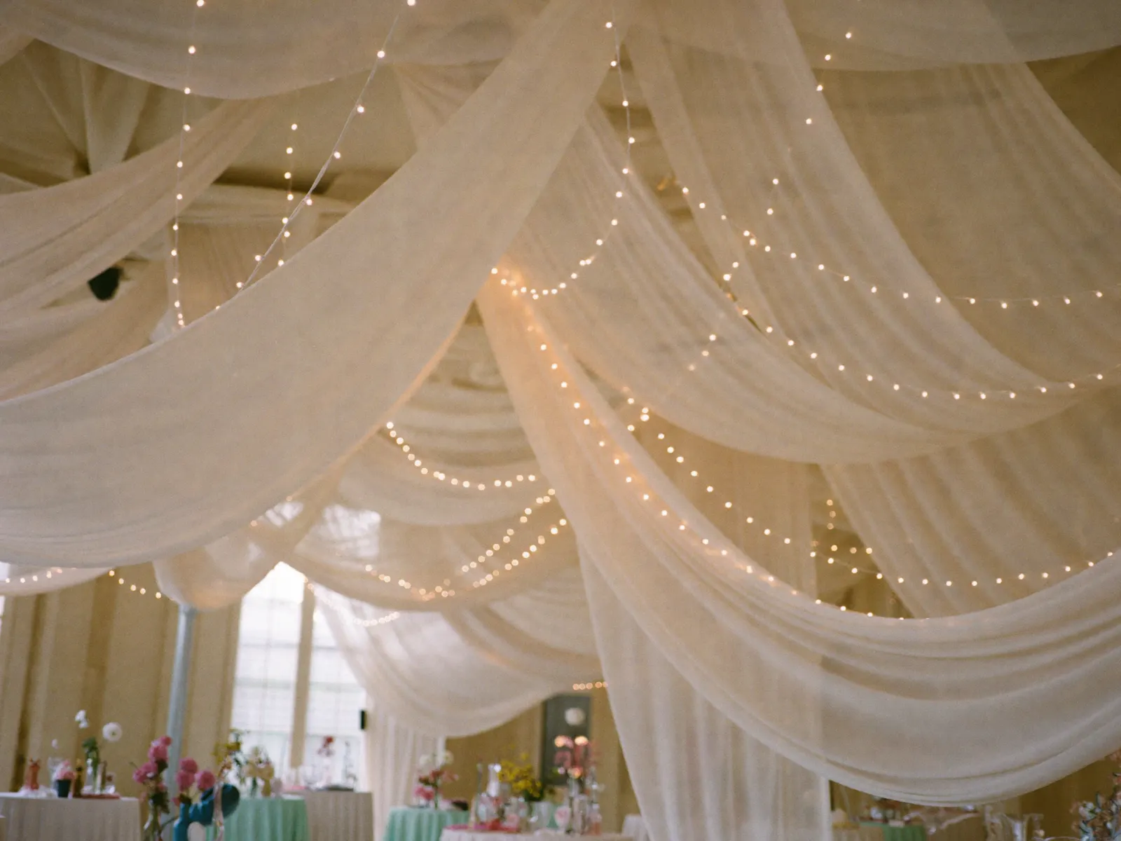 Sheer ceiling draping with warm lights