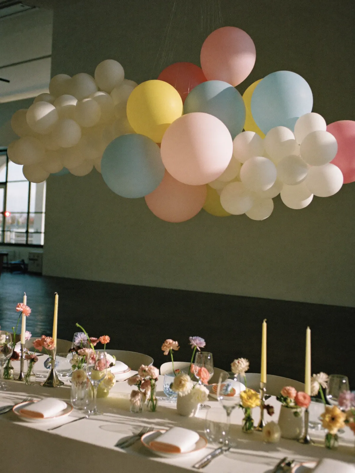 A balloon cloud over a dressed dining table